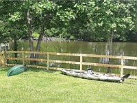 <b>Pressure treated 3-rail ranch rail fence with black mesh and single arched gate</b>